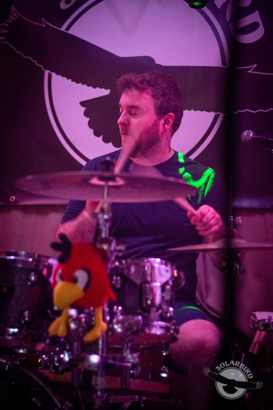 Edd pounding the drums in rock band Solarbird